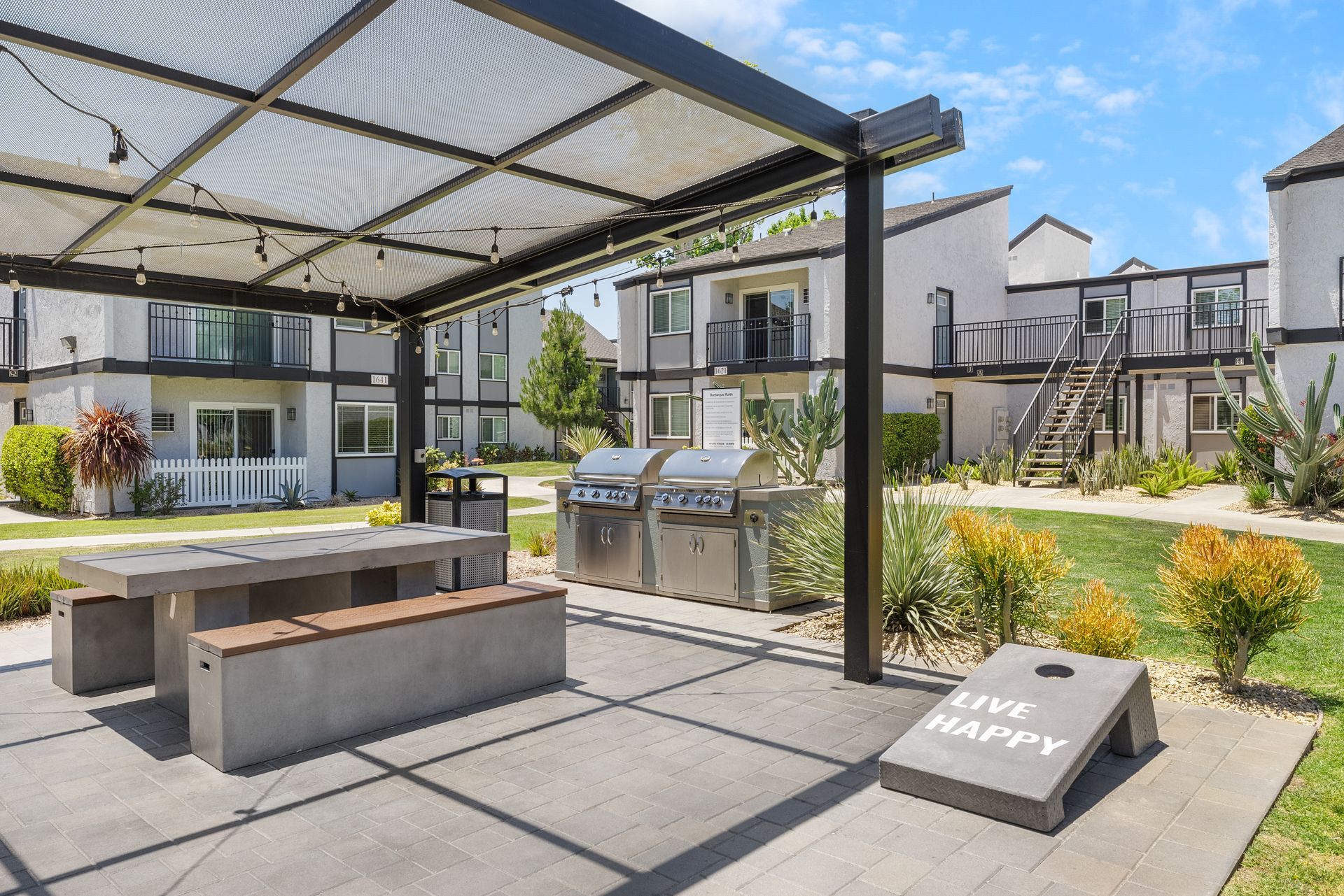 BBQ grills, picnic table, and cornhole