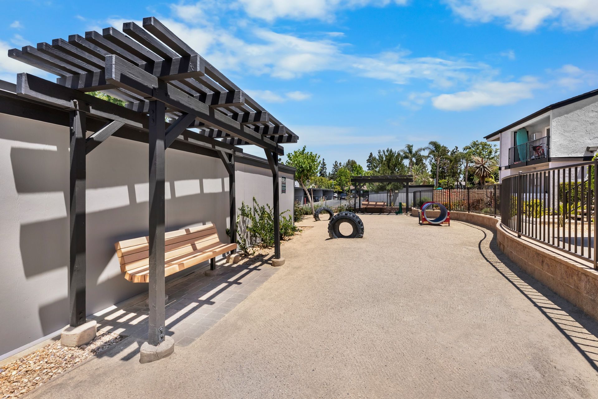 dog park with bench and dog agility equipment