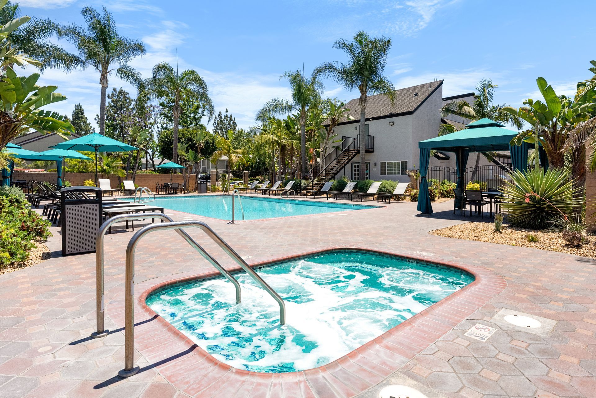 jacuzzi spa and pool with lounge chairs