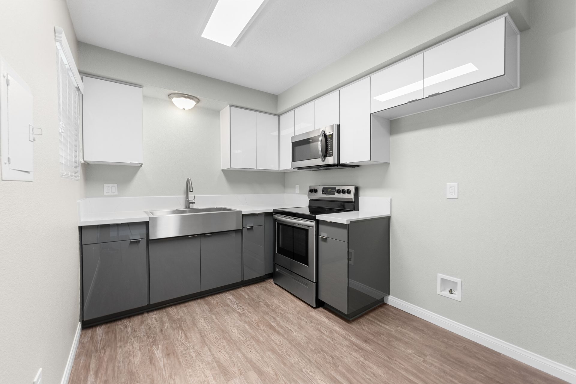 Kitchen with stove, sink, and microwave