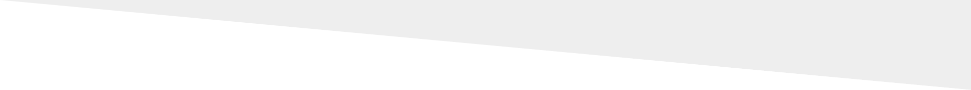 A blurry, light gray diagonal shape against a white background.