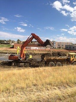 tractor dumps dirt - construction in WY