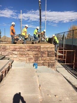workers build brick wall - municipal construction in WY