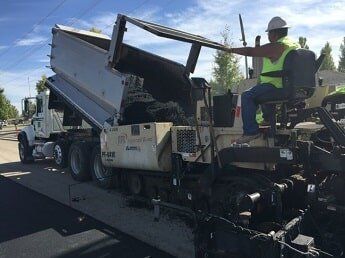 man ride loads asphalt - road construction in WY