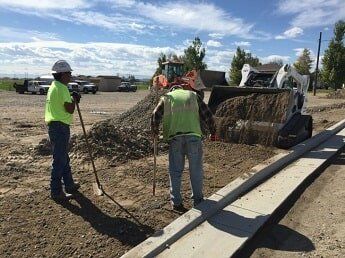 workers move dirt - road construction in WY