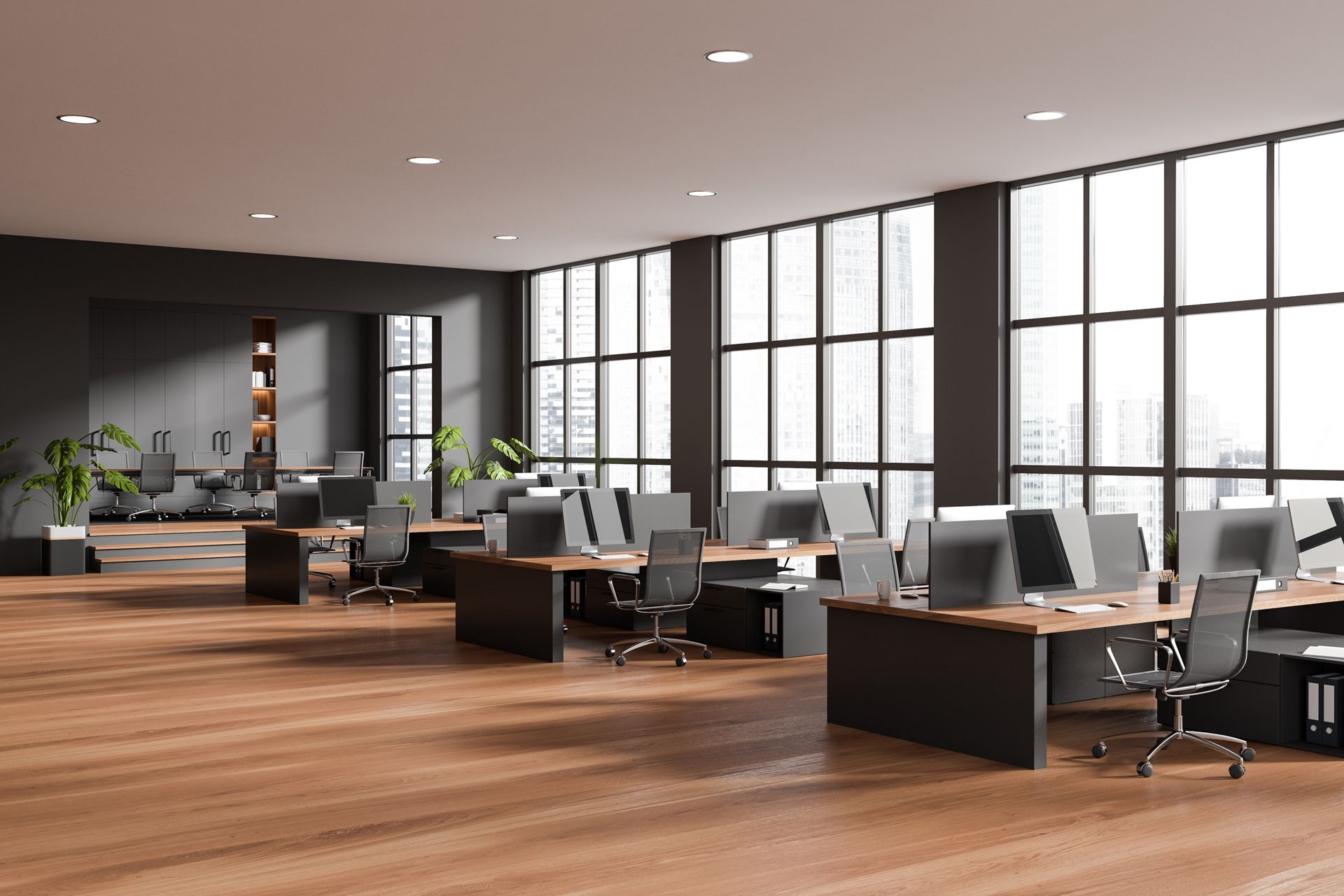 An empty office with wooden floors and lots of windows.