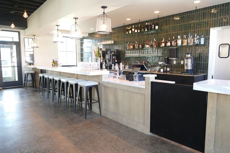 A restaurant with a long bar and stools
