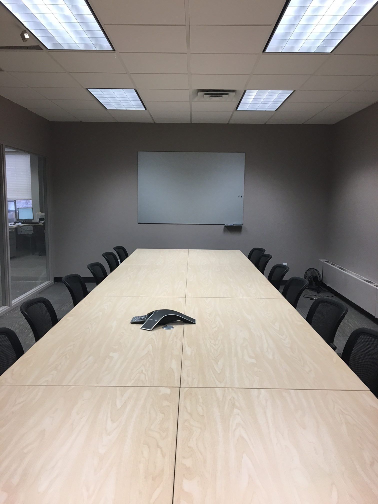 A conference room with a long table and chairs