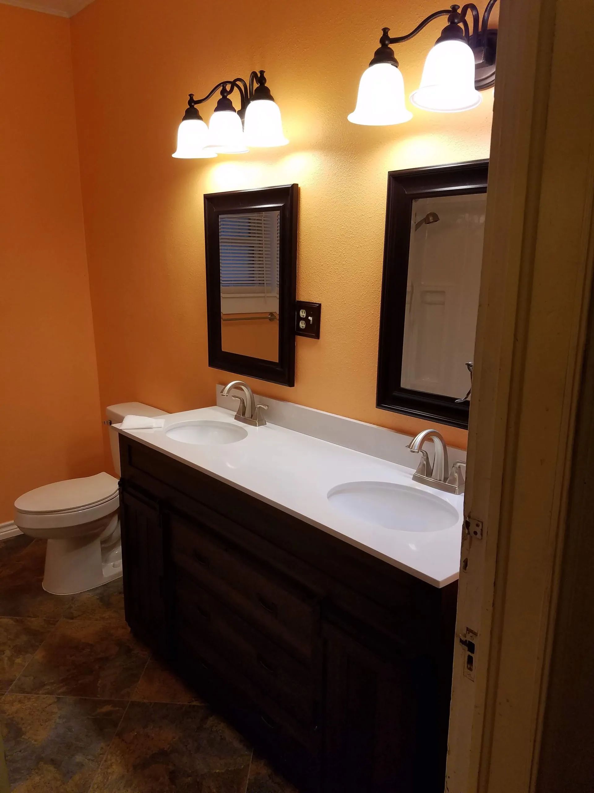 A bathroom with two sinks and two mirrors