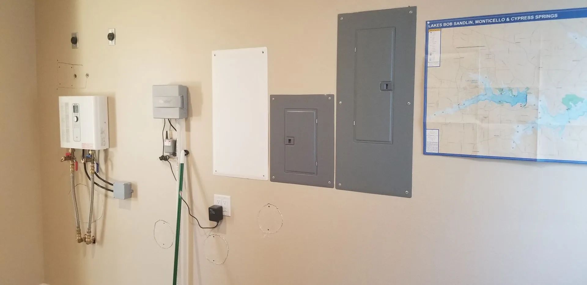 A person is working on an electrical box with a screwdriver.