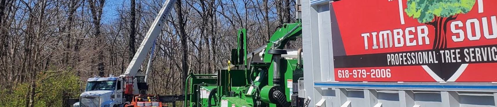 Tree service equipment near a sign that says 