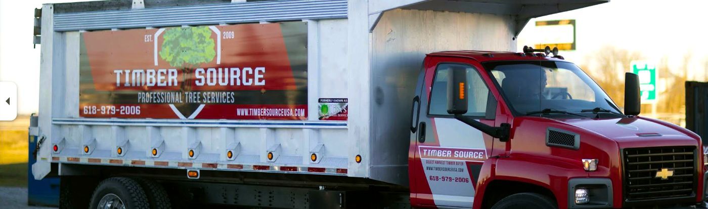 Red Timber Source truck. White storage container on truck with Timber Source signage.