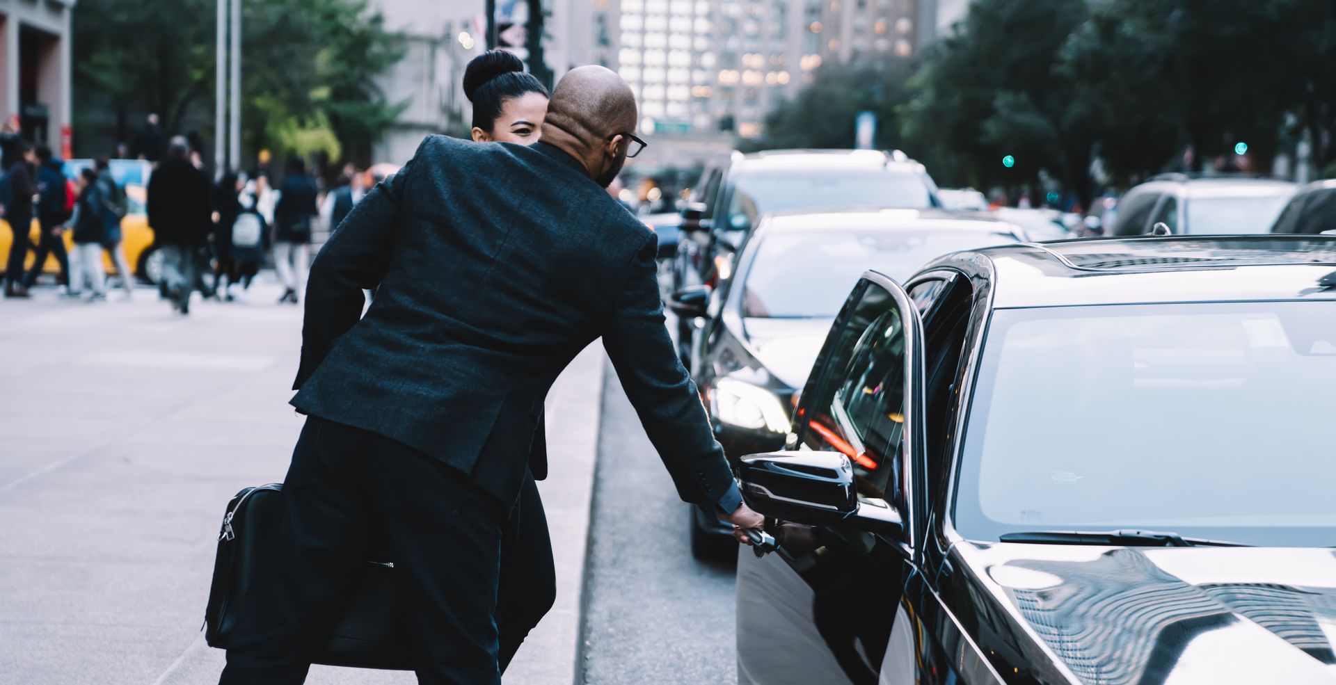 Family gathered at a dining table in a kitchen. They are eating and talking together.