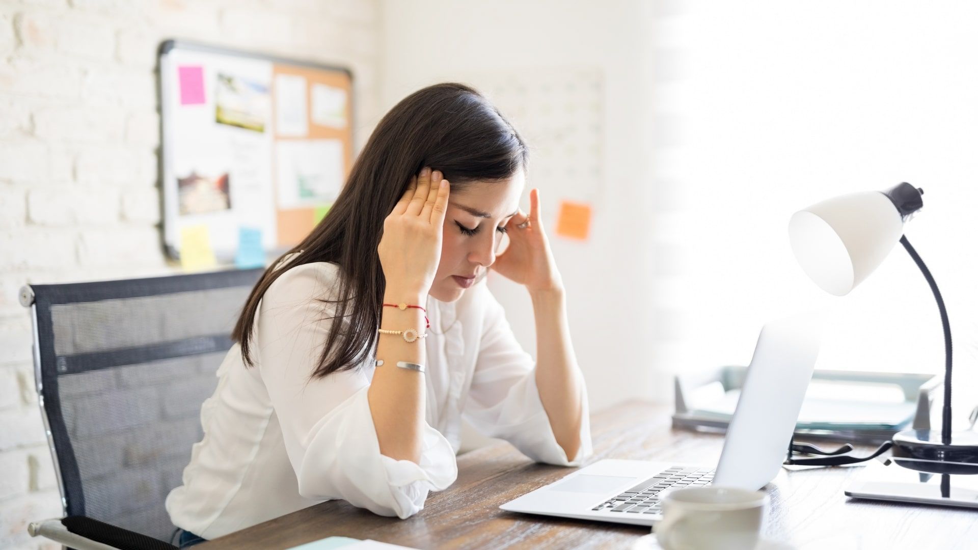 A woman with a headache and fatigue.