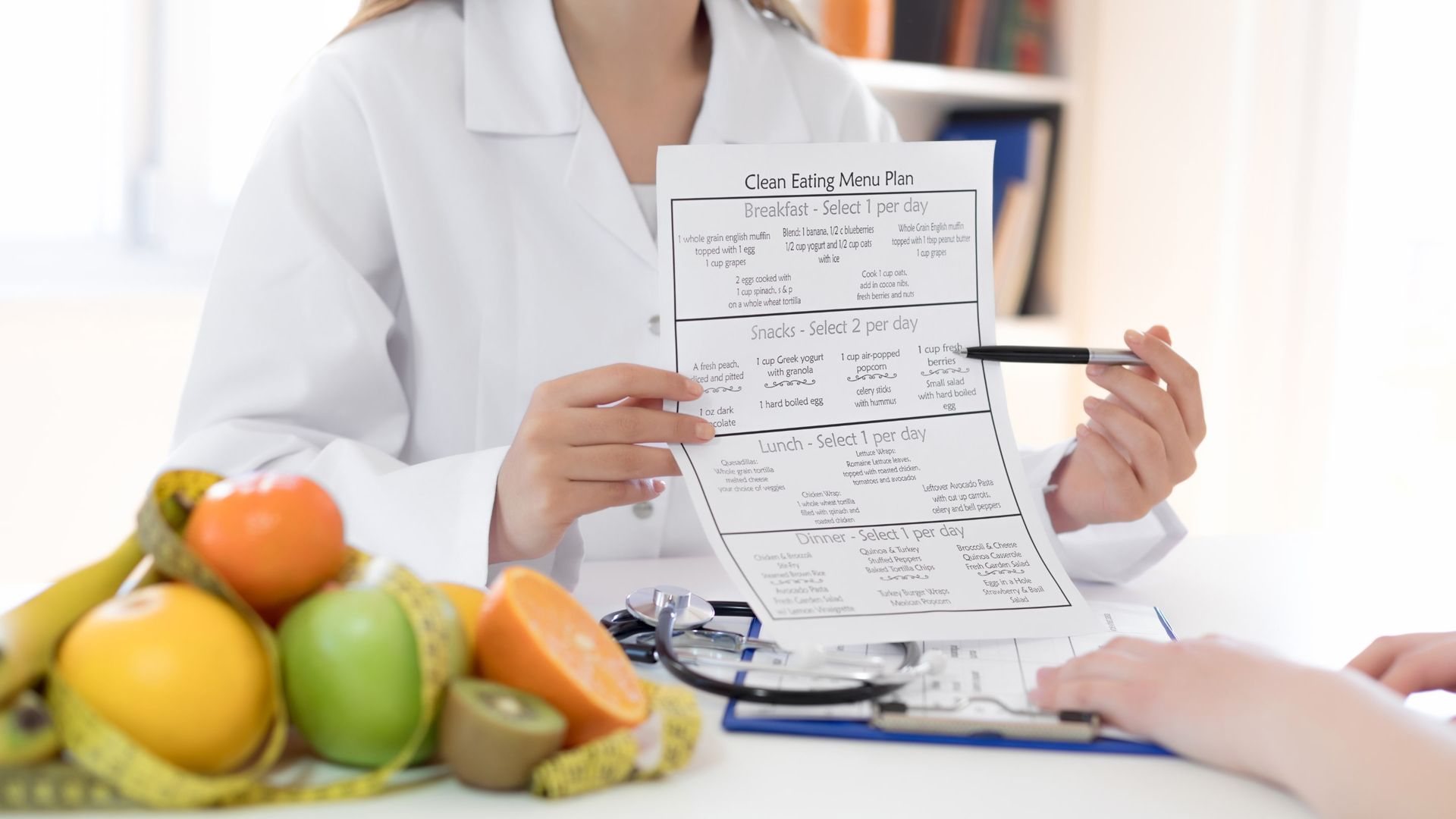 A dietitian explaing their new meal plan to a patient.