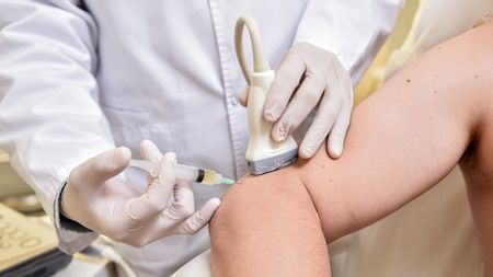 A patient receiving PRP injections for elbow pain.