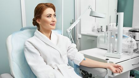 A woman in a robe receiving Ozone therapy.