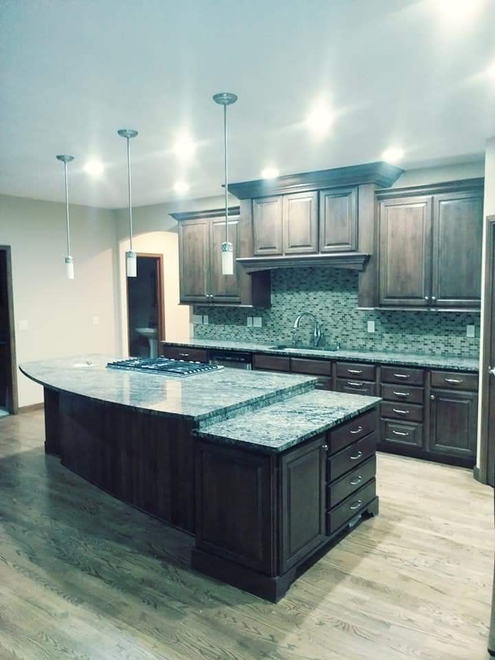 A kitchen with wooden cabinets and granite counter tops