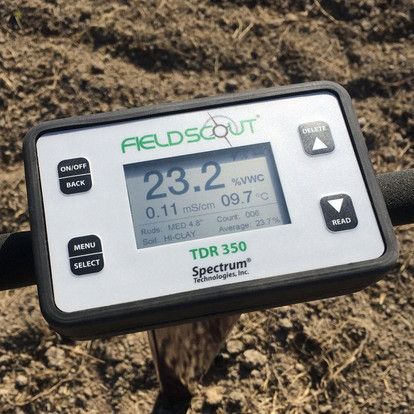 A fieldscout tdr 350 spectrum device is sitting in the dirt.