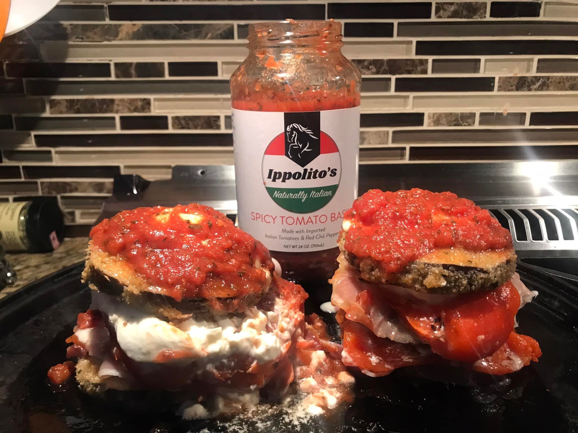 A bottle of ippolito 's spicy cheese sauce next to a stack of food