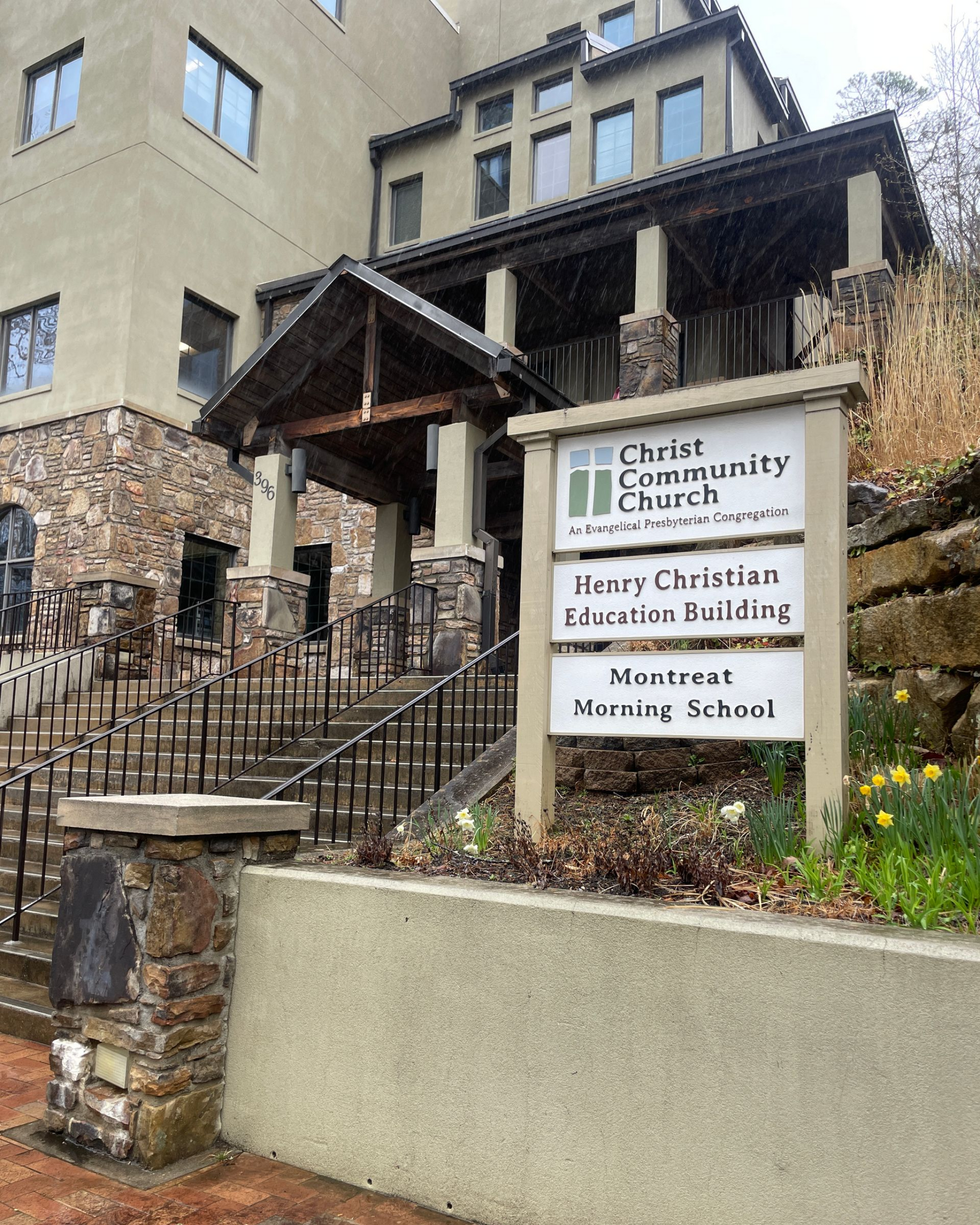 Church building with steps and sign for Henry Christian Education Building and the Montreat Morning School.