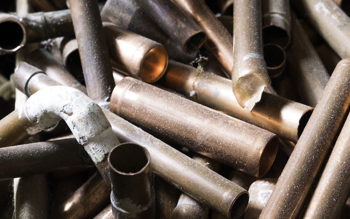 Pile of tarnished copper pipes.