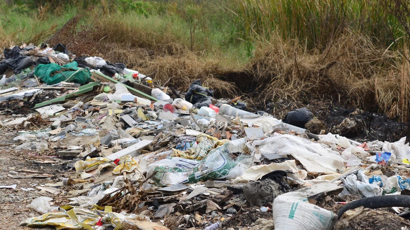 Fly tipping by the side of a road.