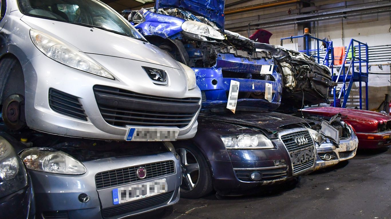 A bunch of cars are stacked on top of each other waiting to be scrapped by Benfleet Scrap