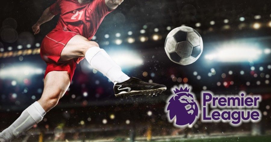 Soccer player kicking a ball in a stadium, Premier League logo.