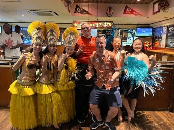 A group of people are posing for a picture in a restaurant.