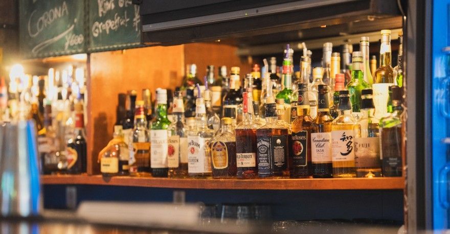 Nagoya sports bar with various whisky bottles lined up on a wooden counter.