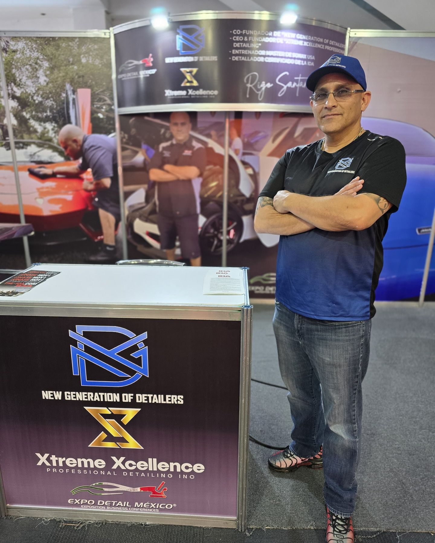 A man standing in front of a sign that says xtreme excellence