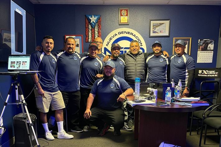 A group of men are posing for a picture in a room.