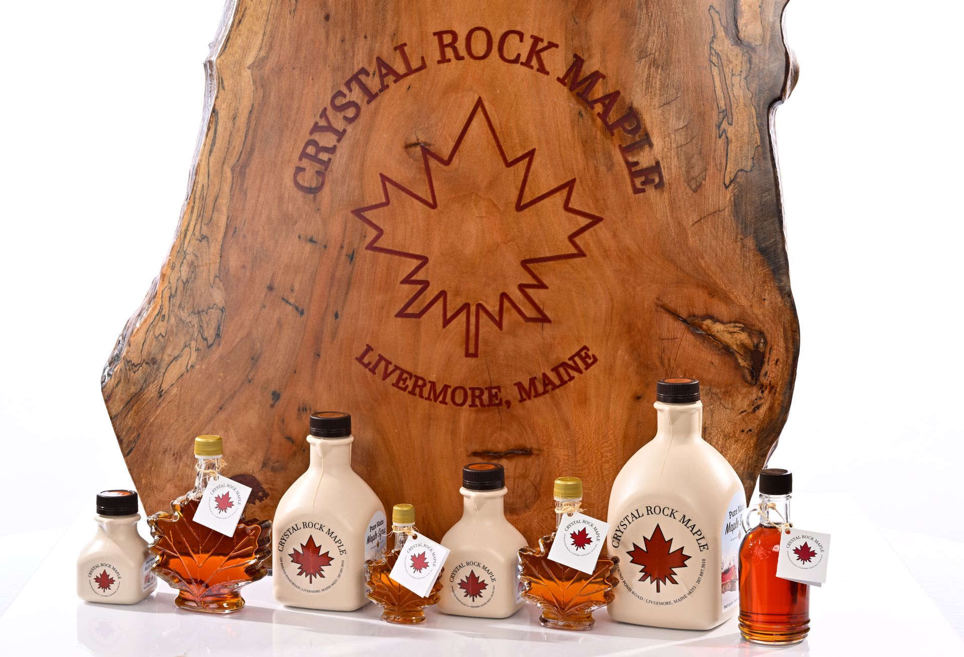 Crystal Rock Maple syrup bottles with a wooden sign in Livermore, Maine.