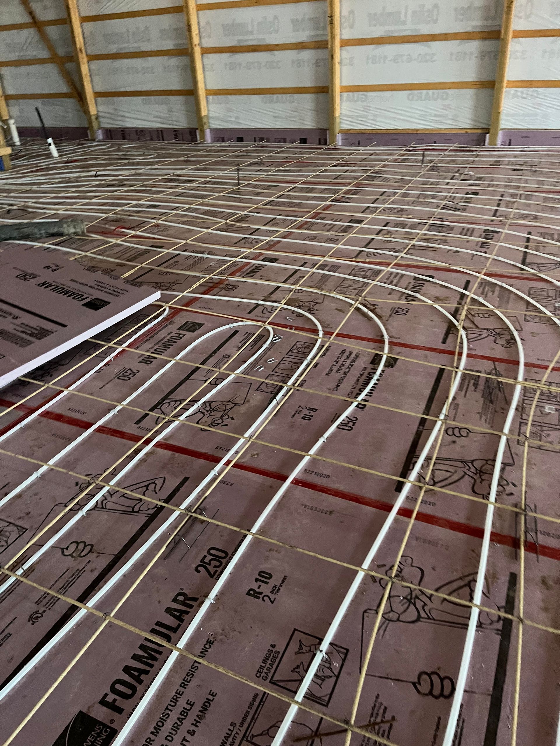 A large room with a lot of pipes on the floor.