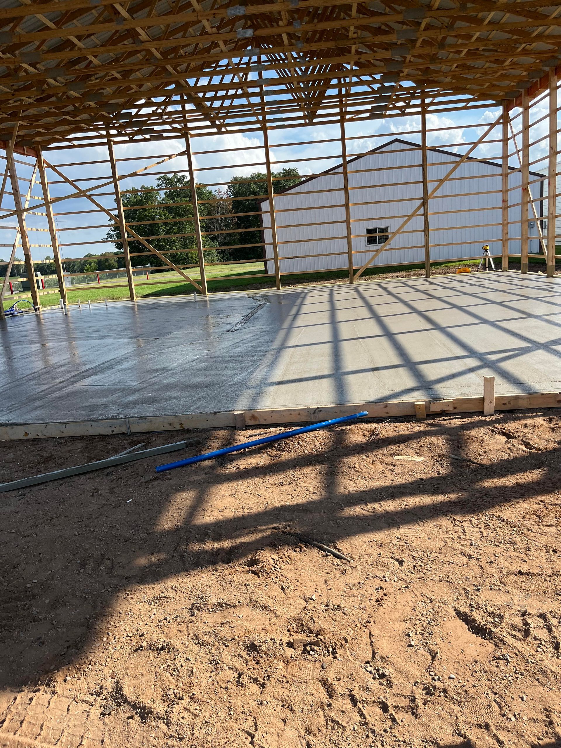 A concrete floor is being poured in a building under construction