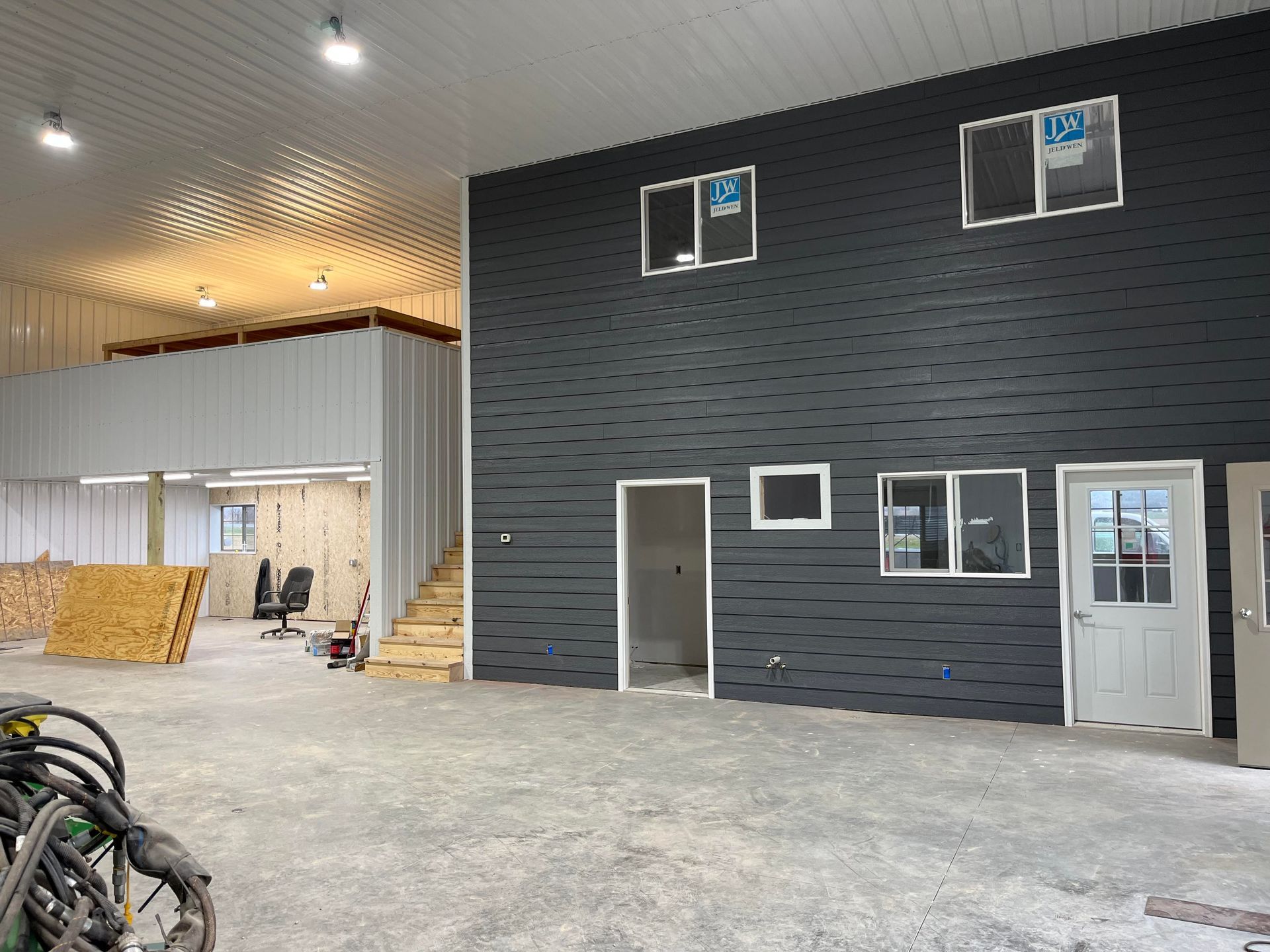 A large empty building with a lot of windows and doors.