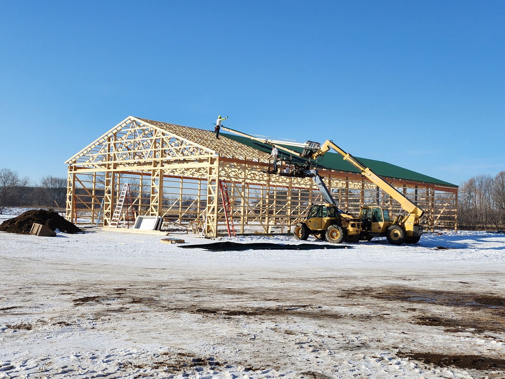 A large building is being built in the snow.