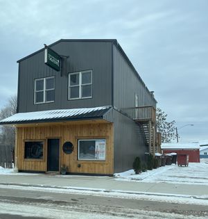 A large building with a sign on the side that says ' wings '