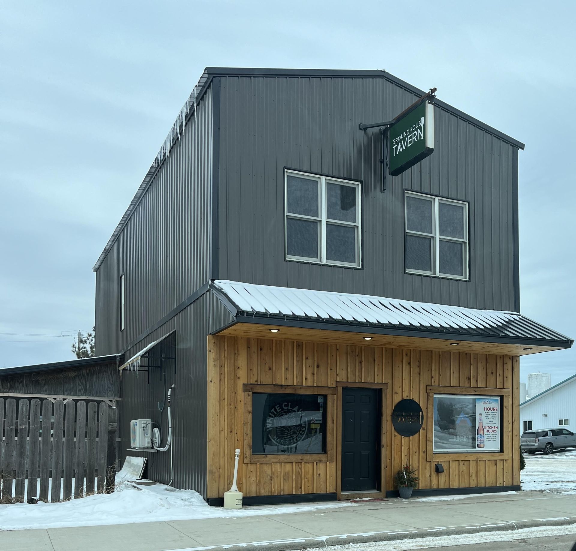 A large building with a wooden facade and a sign that says ' acorn ' on it.