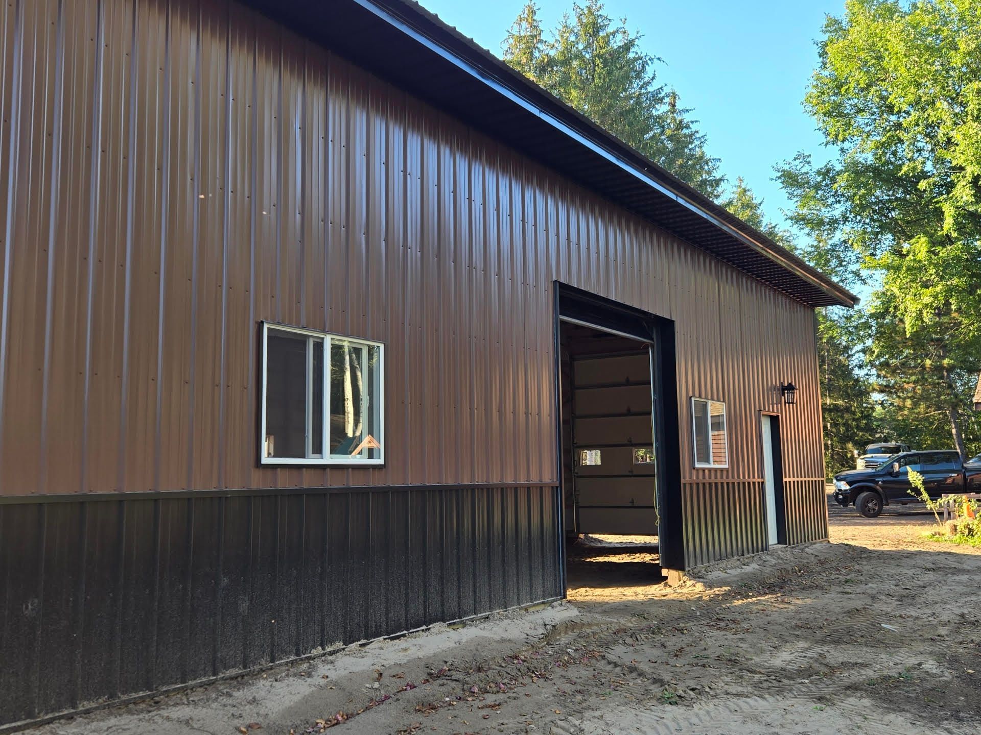 A brown and black building with a garage door