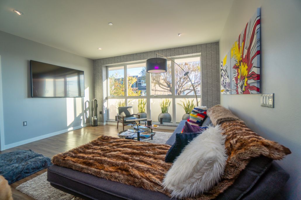 A living room with a couch and a flat screen tv.