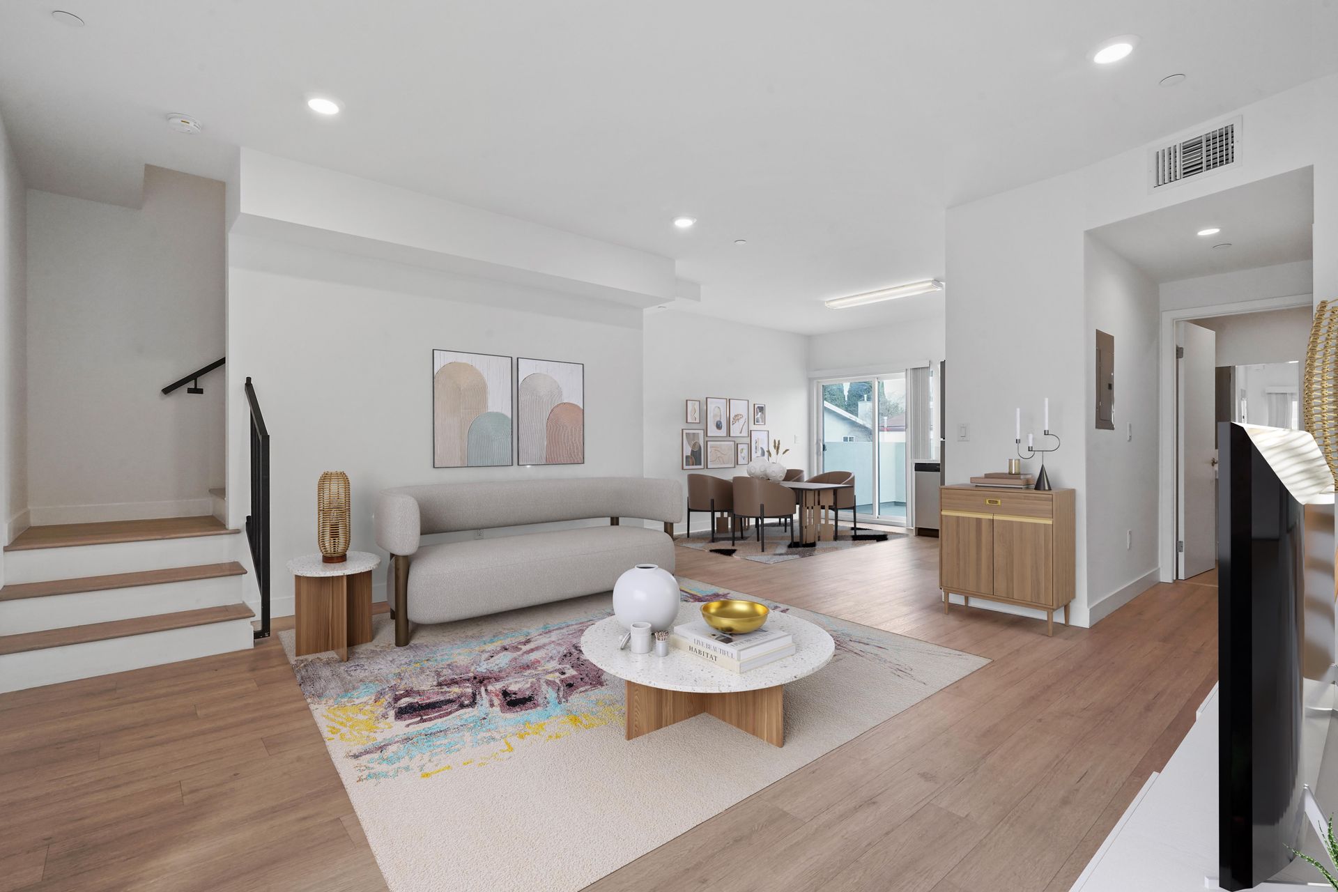 A living room with a couch , coffee table , and television.