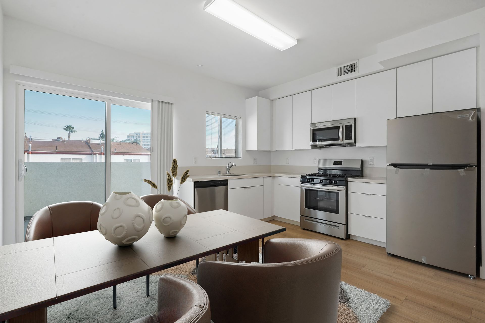 A kitchen with a table and chairs and a refrigerator