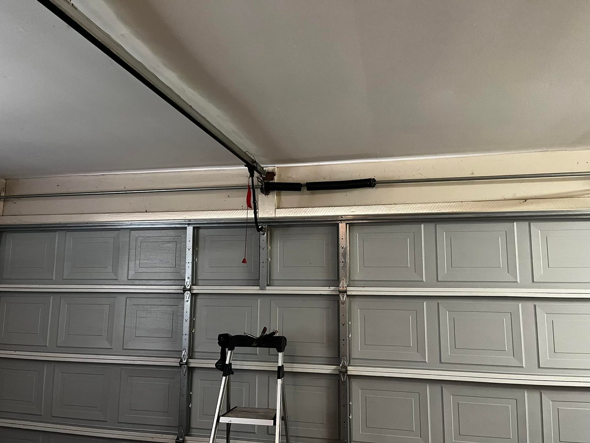 A garage door with a ladder attached to it.