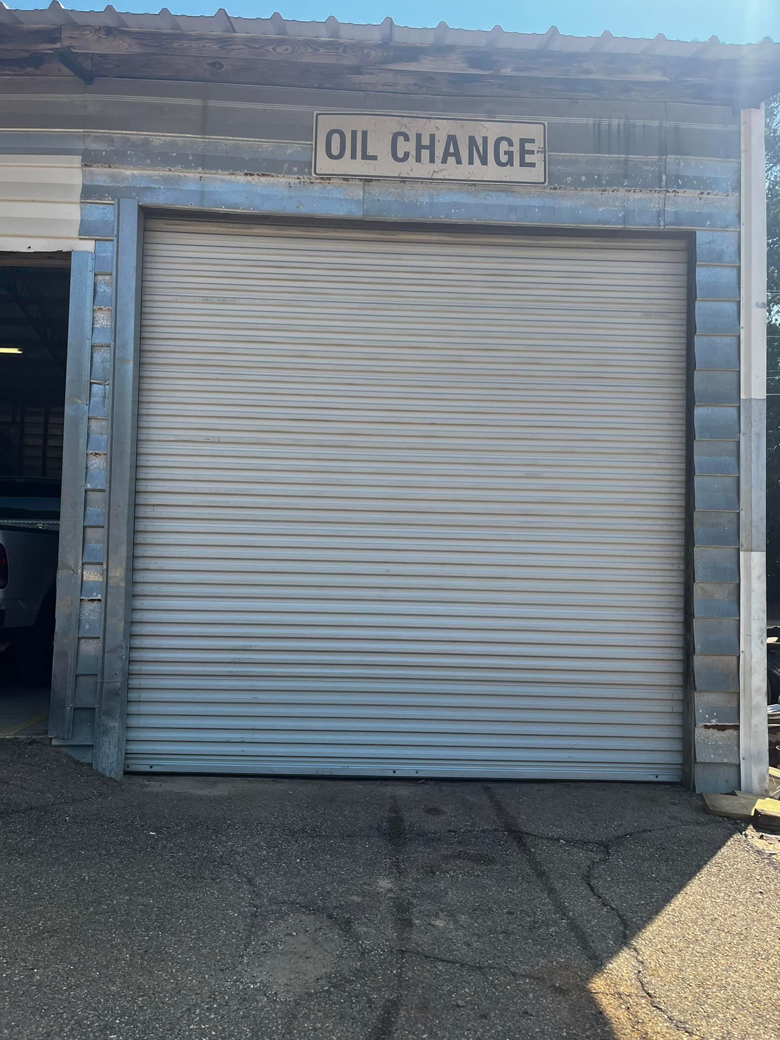 A garage door with a sign that says oil change on it.
