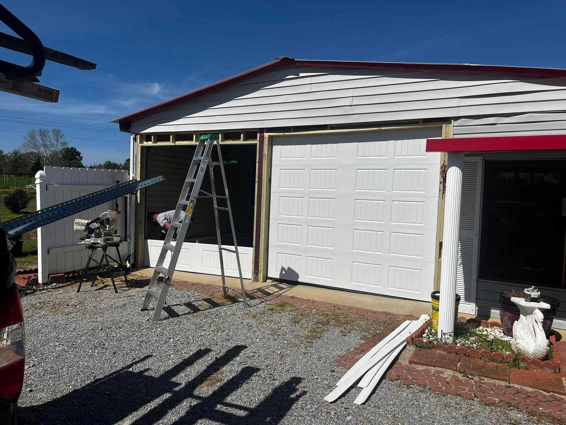 A garage door is being installed on a house.