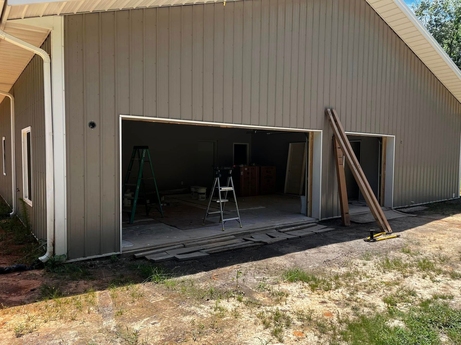 A garage is being built in the backyard of a house.