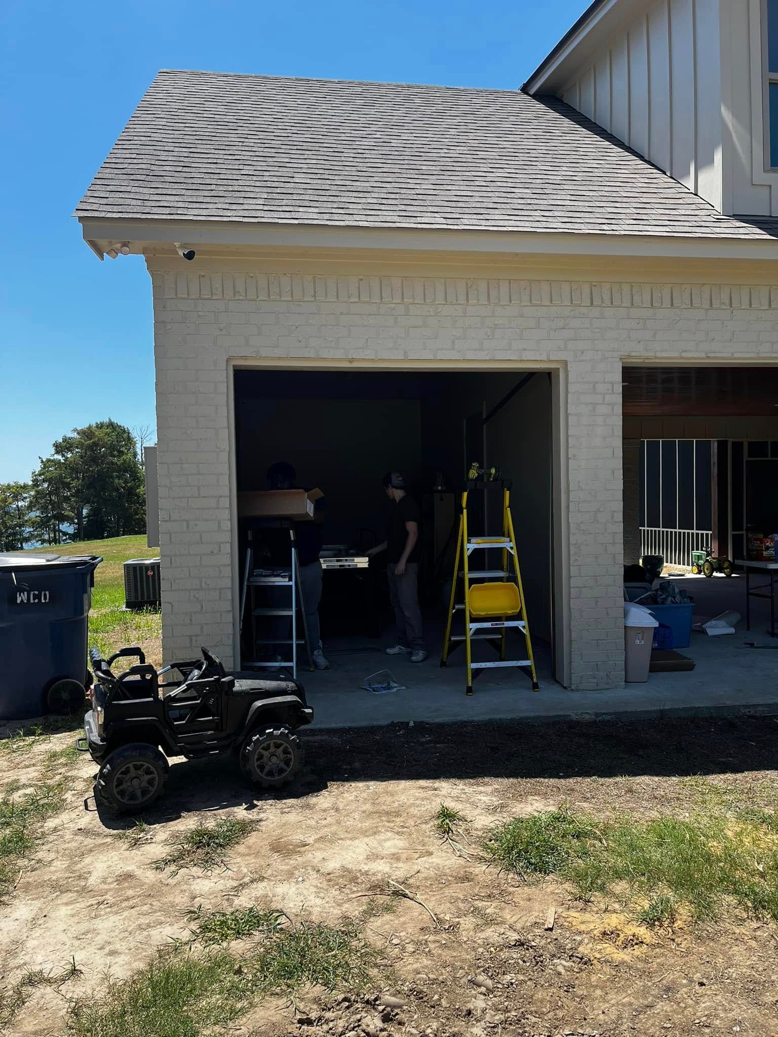 A toy car is parked in front of a garage door.