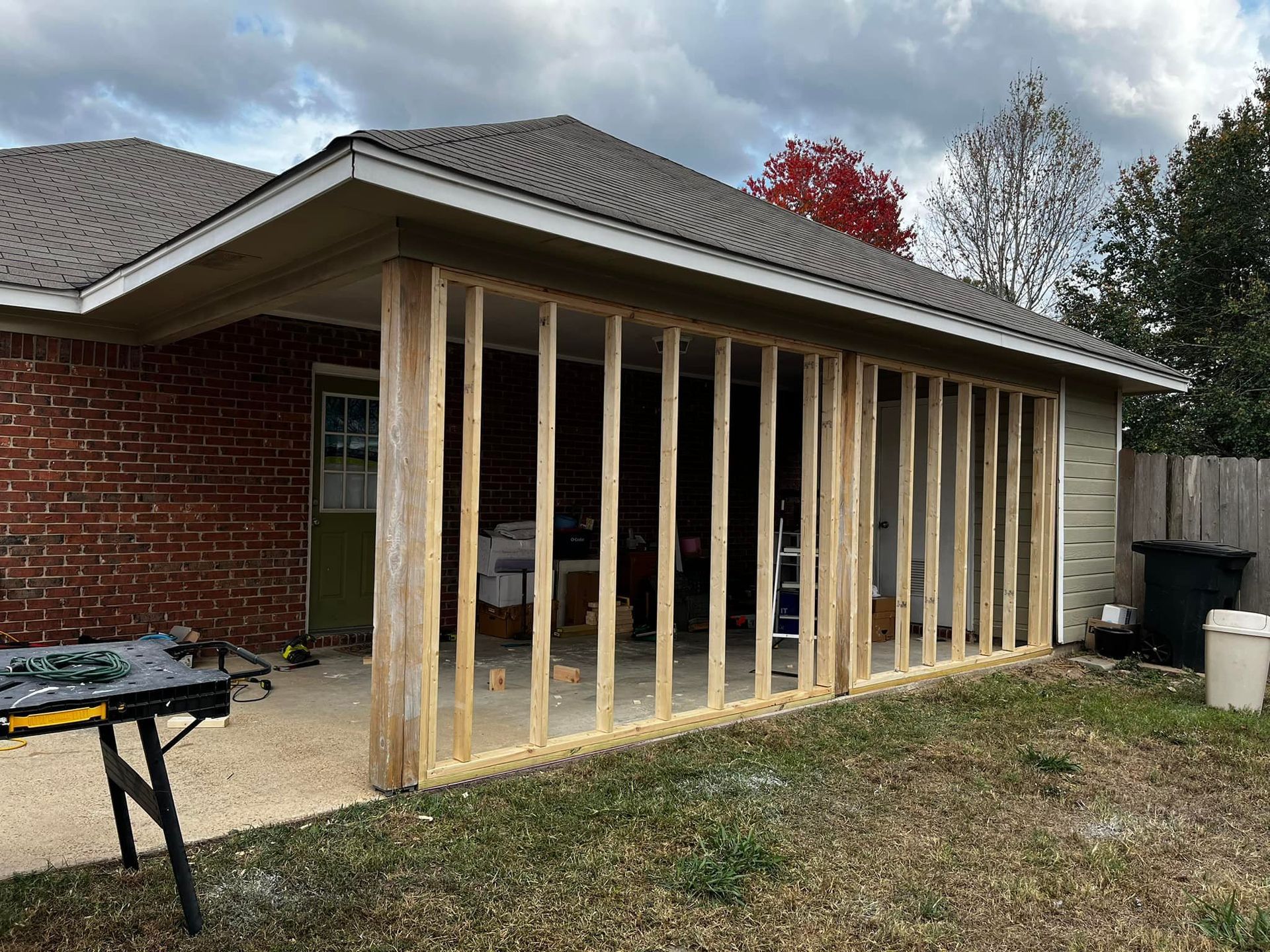 A wooden frame is being built on the side of a house.